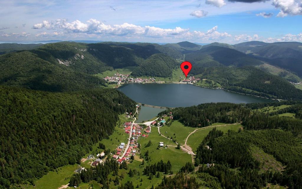 a red hot air balloon flying over a lake at Hotel Priehrada in Dedinky