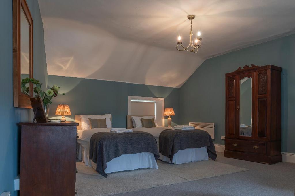a bedroom with two beds and a mirror and a dresser at Number 4 in Longford
