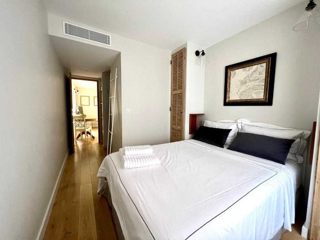 a bedroom with a large white bed in a room at Les Petits Volets 3 appartements au choix in Antibes