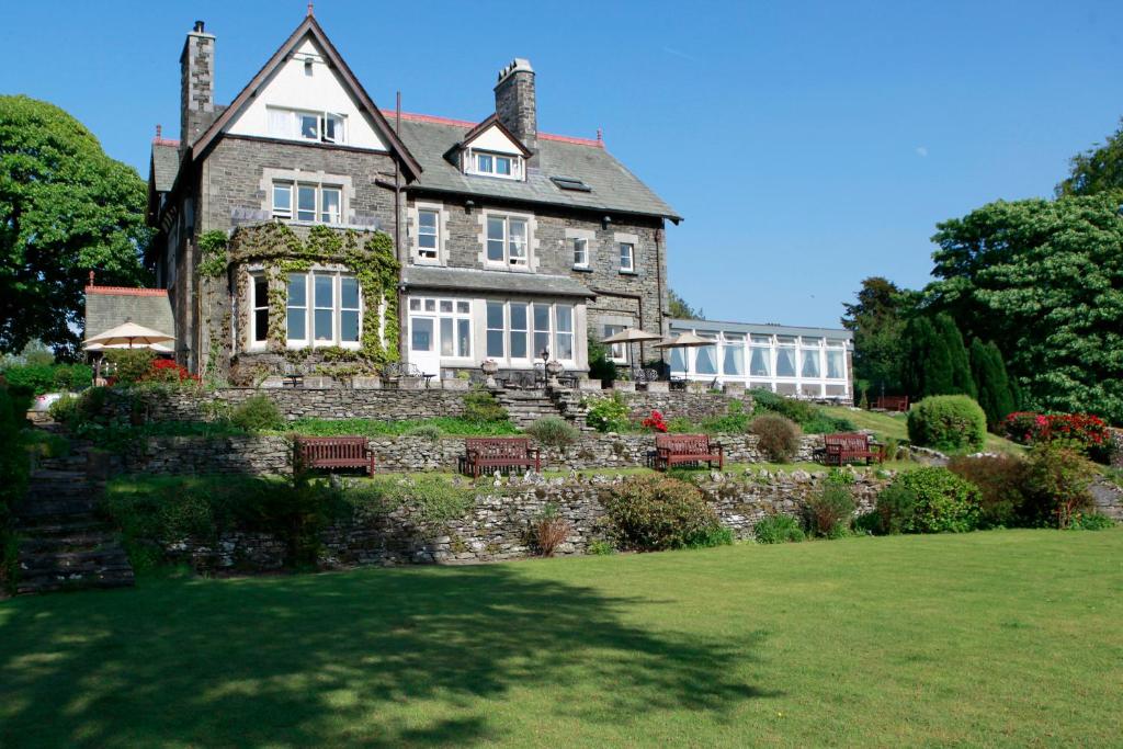 an old stone house with a garden in front of it at Sawrey House in Near Sawrey