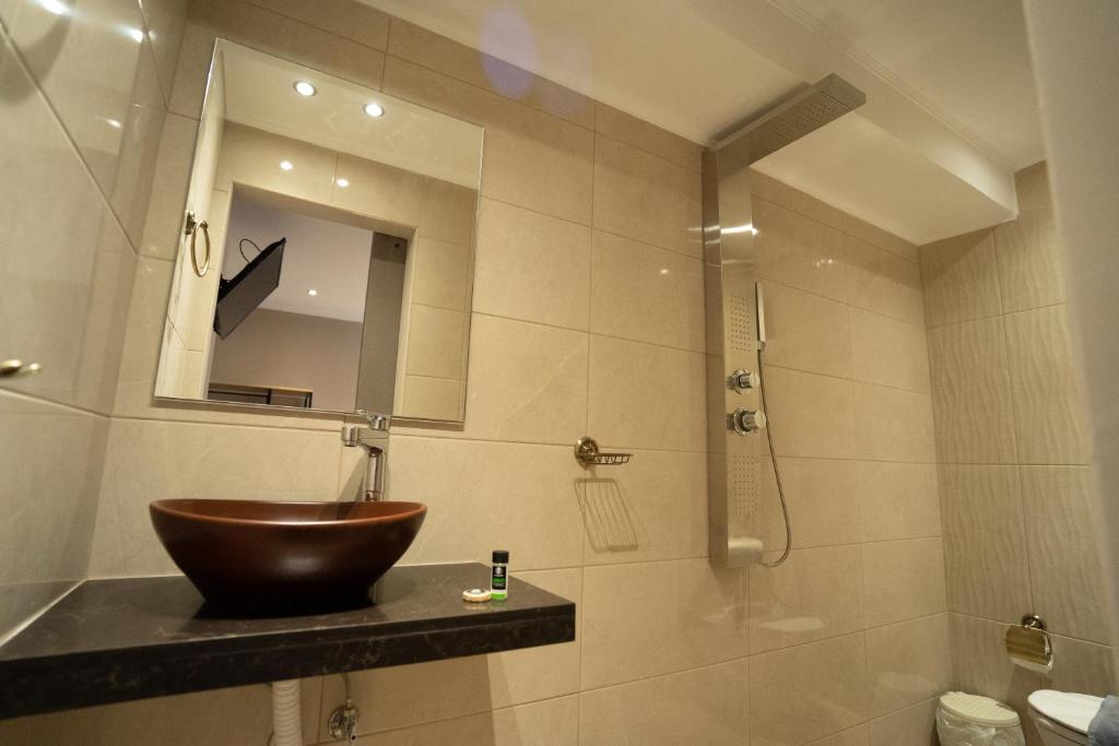 a bathroom with a bowl sink and a shower at Parthenis Riviera Hotel in Athens