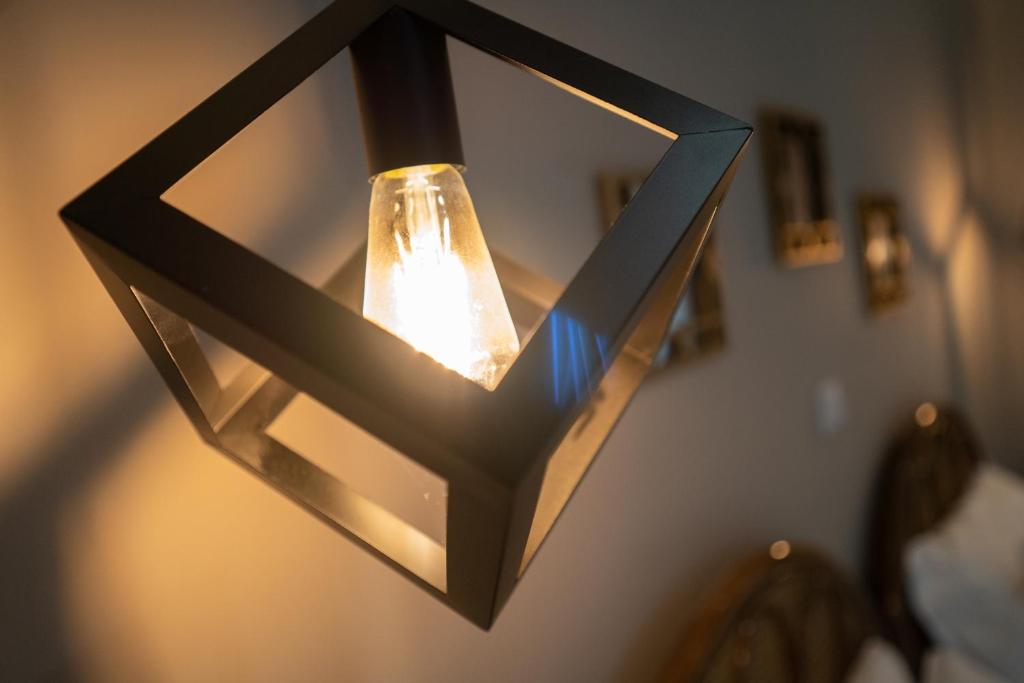a light fixture hanging from a wall at Parthenis Riviera Hotel in Athens