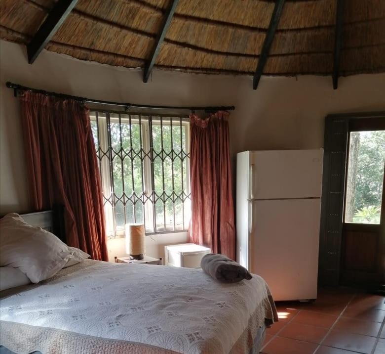 a bedroom with a bed and a large window at Sielevreugde in Eersbewoond