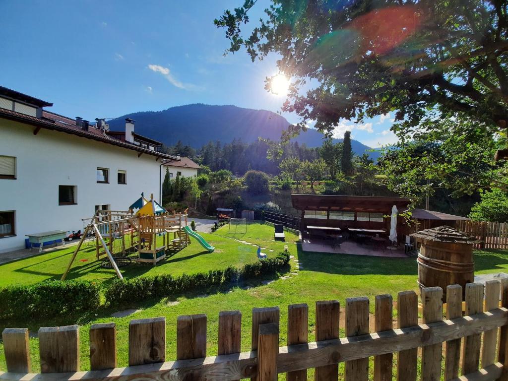 a backyard with a playground with a wooden fence at Falgerhof in Vollan