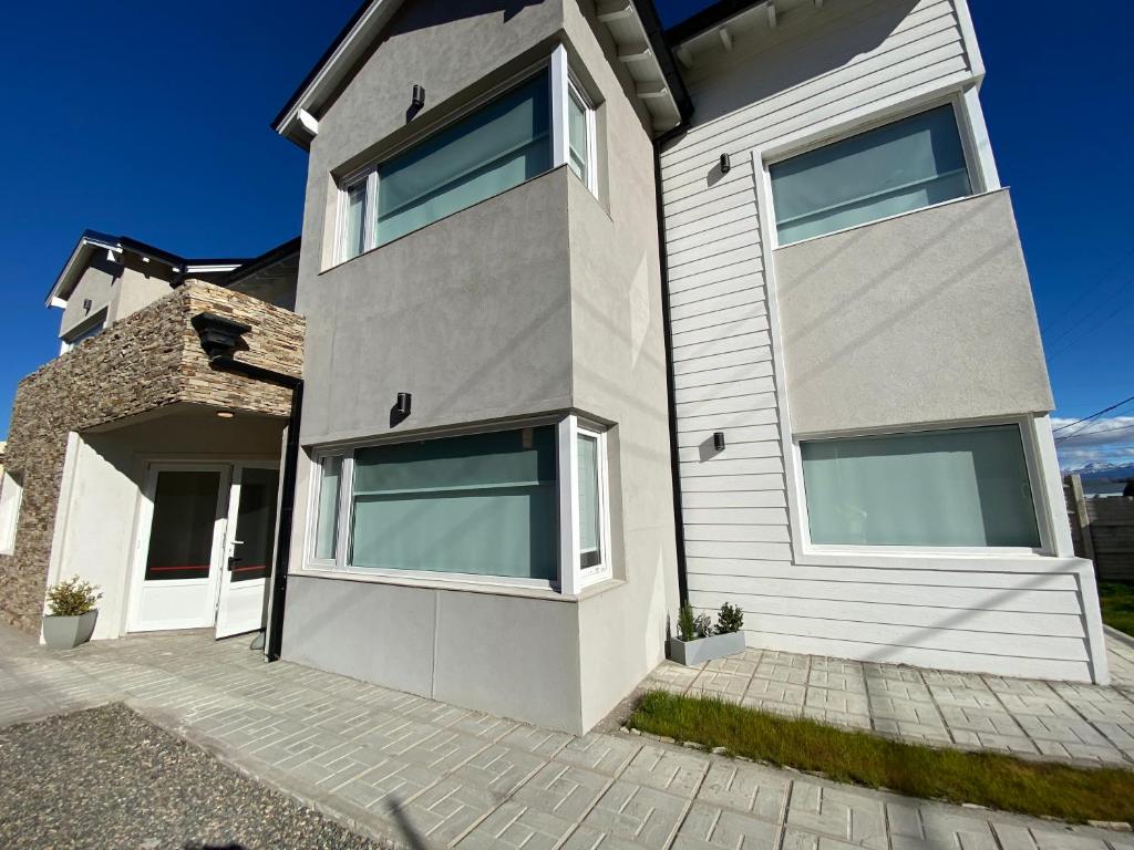 a house with large windows on the side of it at Las Cuatro Estaciones in Esquel