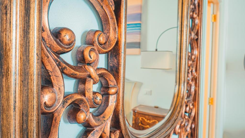 a close up of a mirror with a wooden frame at Galatina 1939 in Galatina