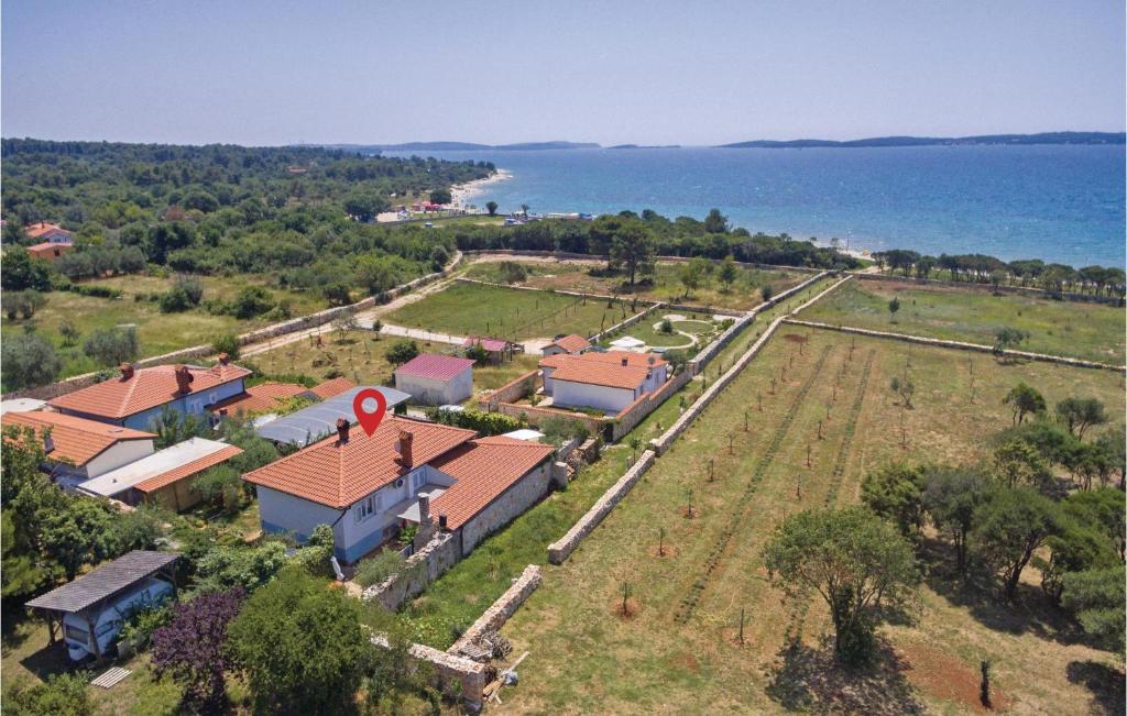 an aerial view of a house with the ocean in the background at Gorgeous Home In Vodnjan With House Sea View in Vodnjan