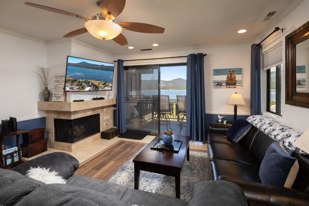a living room with a couch and a fireplace at Big Bear Lakefront condo- walk to village in Big Bear Lake