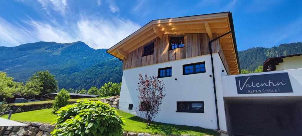 a house in the mountains with a building at Alpenchalet Valentin in Sautens