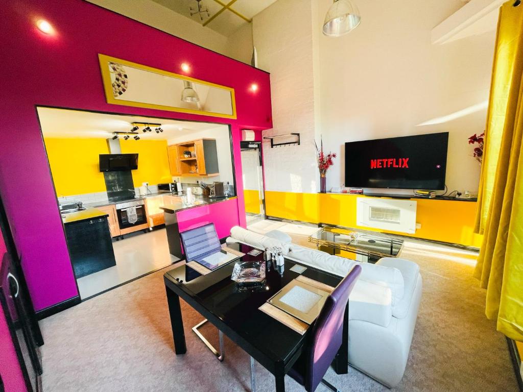 a living room with a white couch and a table at PHOENIX Apartments in Goole