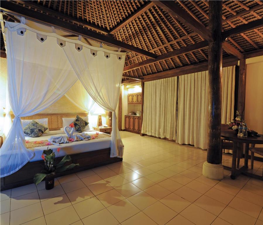 Postel nebo postele na pokoji v ubytování Bumi Ubud Resort