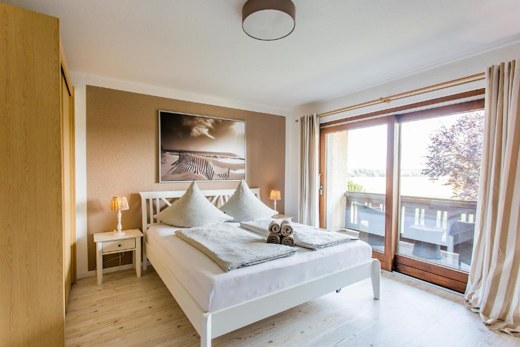 a bedroom with a bed and a large window at Gästehaus Chalet-Perle in Bad Füssing