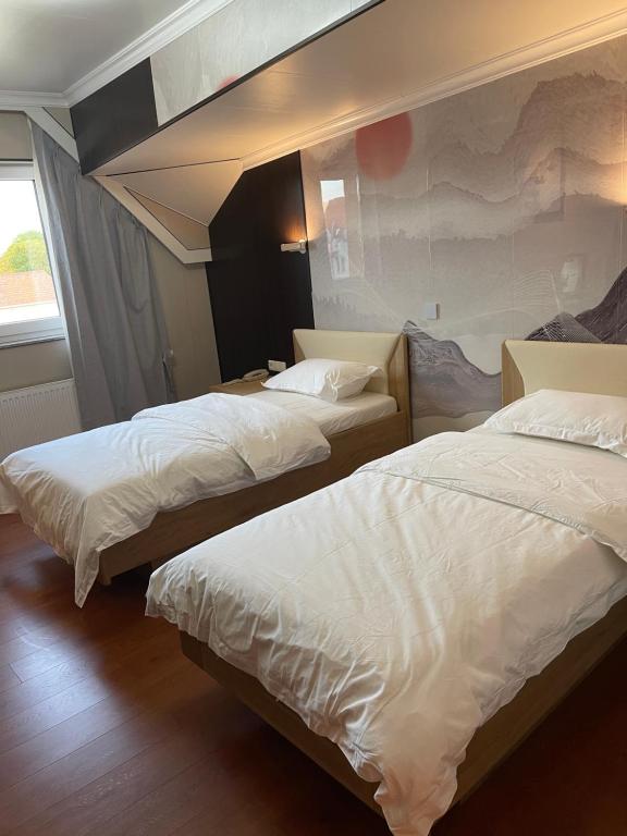 Postel nebo postele na pokoji v ubytování Mr.Liao Hotel