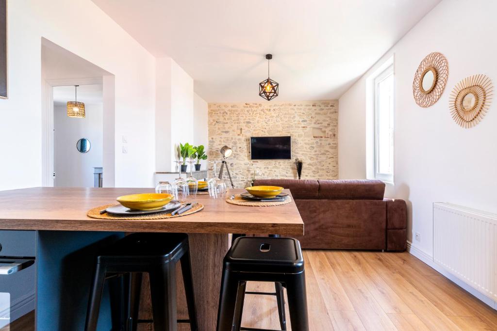 Le Liondor في مونتيليمار: مطبخ وغرفة معيشة مع طاولة خشبية كبيرة