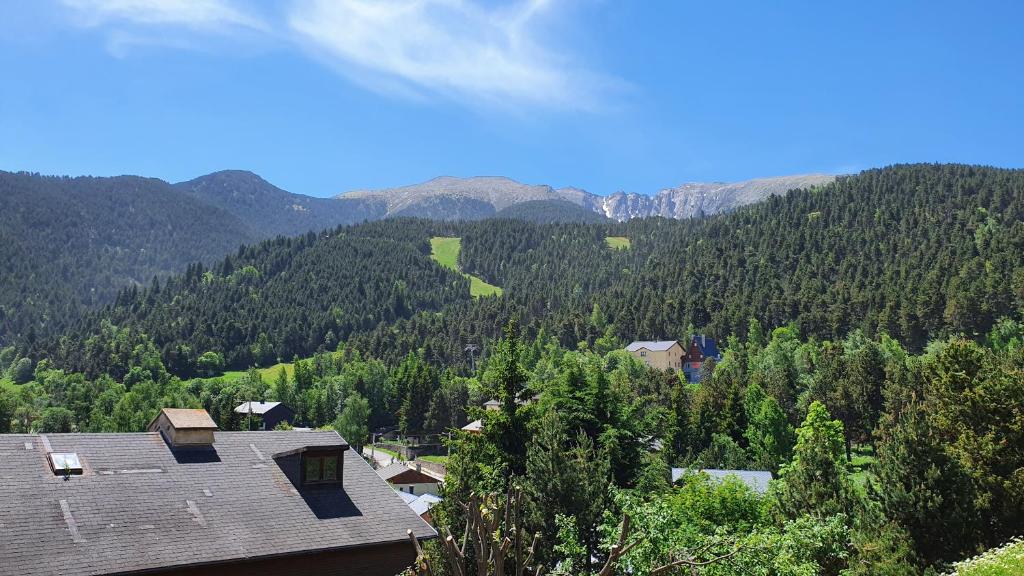 a view of a mountain with trees and a house at Appartement T3 en RDC 54 m2 avec balcon in Saint-Pierre-dels-Forcats