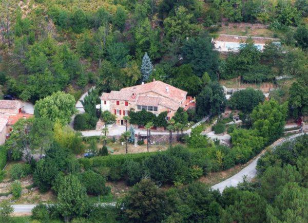 an aerial view of a large house in a forest at Chambre d'hôte Mas d'Alzon à St Jean du Pin in La Barriére