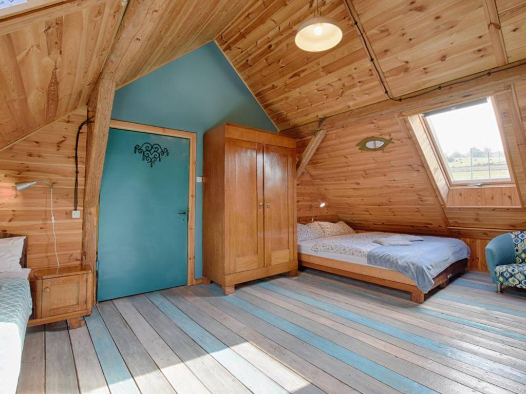 a bedroom with two beds in a wooden cabin at Koko Ryku Agroturystyka in Nowa Ruda
