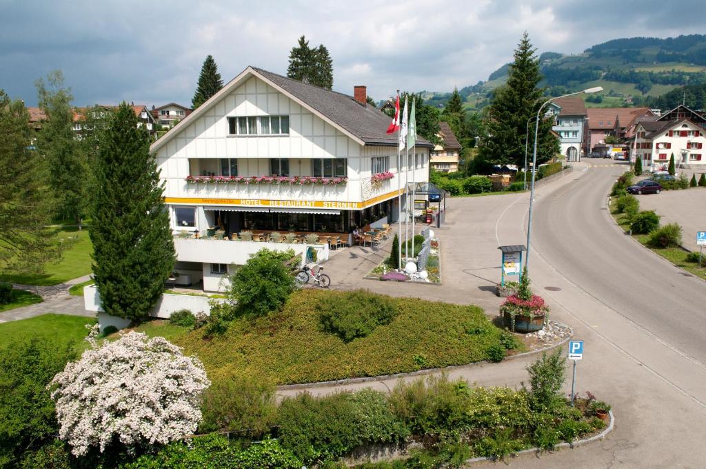 ein großes weißes Gebäude auf einer Straße in einer Stadt in der Unterkunft Hotel-Restaurant Sternen in Nesslau