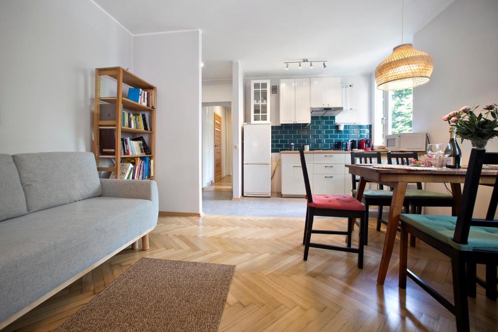 a living room and kitchen with a couch and a table at P&O Apartments Bielańska in Warsaw
