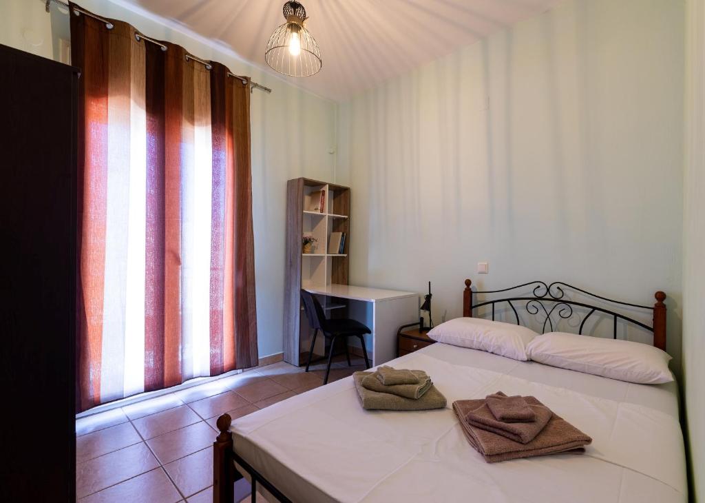a bedroom with a bed with two towels on it at Mrs, Aphrodite's Studio in Chios