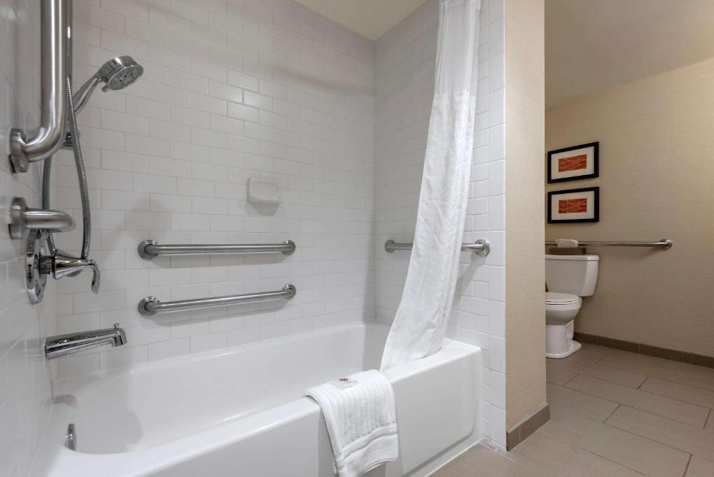 a bathroom with a bath tub and a toilet at Comfort Inn The Pointe in Niagara Falls