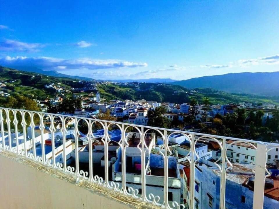 a balcony with a view of a city at NOUARA Appart'hotel in Chefchaouene