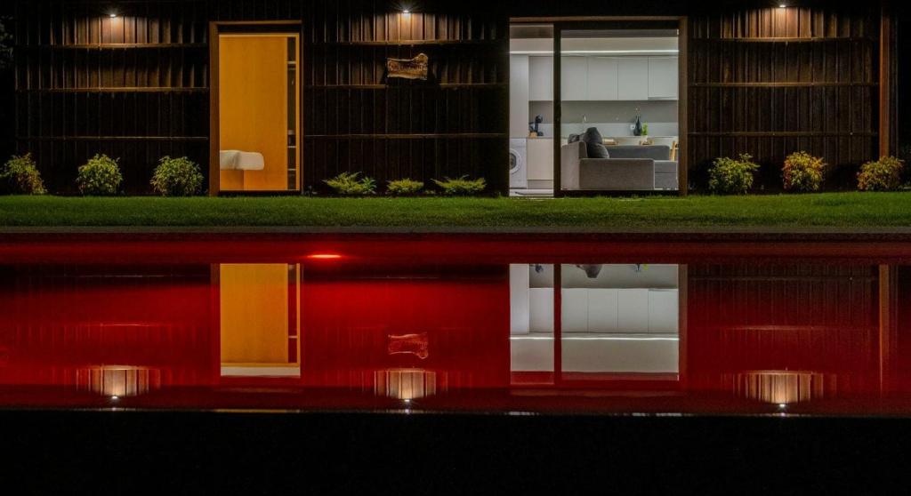 two views of a house at night at Carvalheira Country House - Gerês in Braga