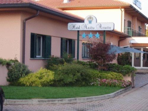 a building with a sign in front of it at Hotel Nastro Azzurro in Monguzzo 