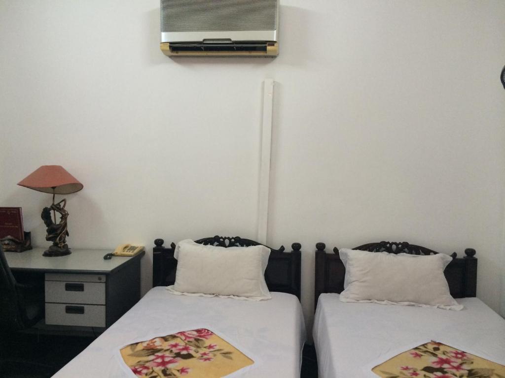 Postel nebo postele na pokoji v ubytování Ngoc Linh Hotel