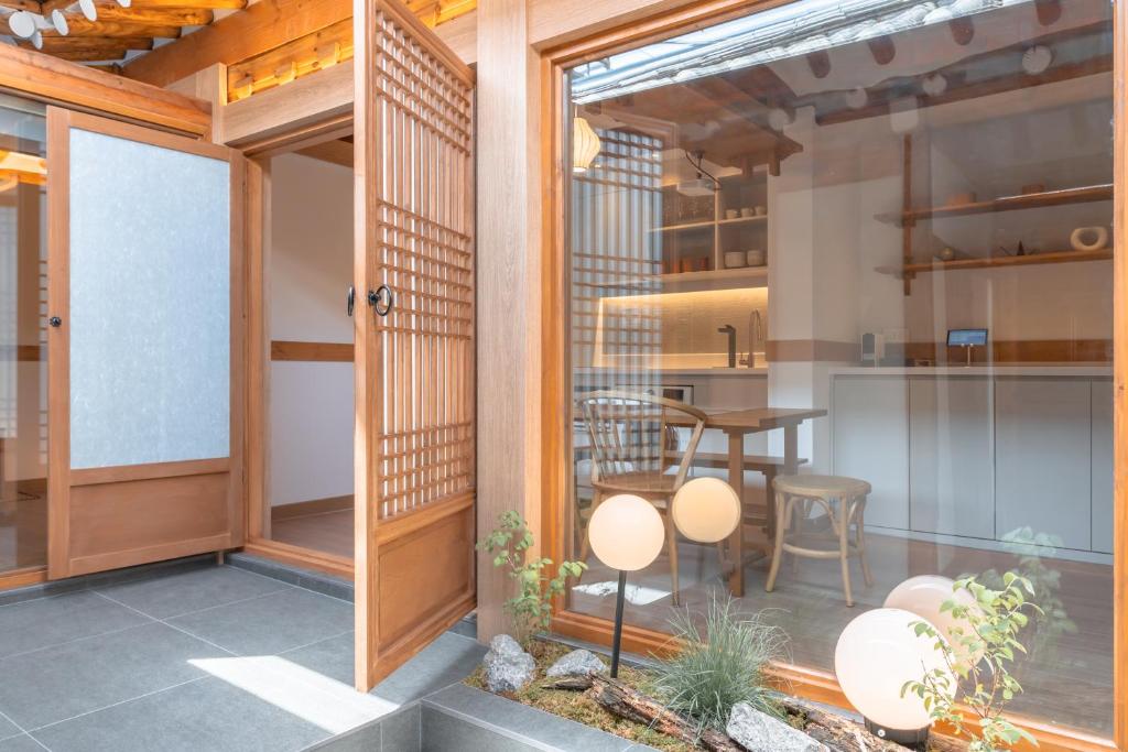 a room with a patio with a table and chairs at Luxury hanok with private bathtub - SW10 in Seoul