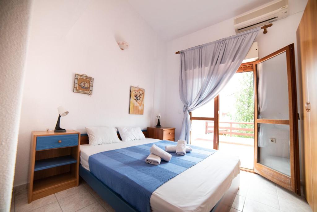 a bedroom with a bed with two towels on it at Perfect House in Pefkochori