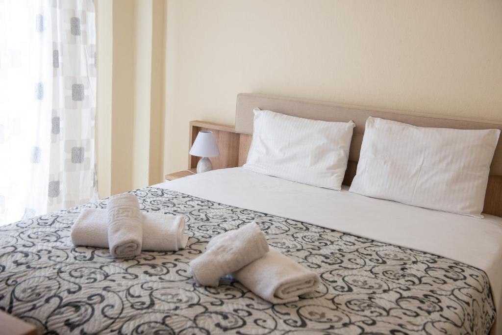 a bedroom with a bed with towels on it at Perfect Apartment in Nea Potidaea