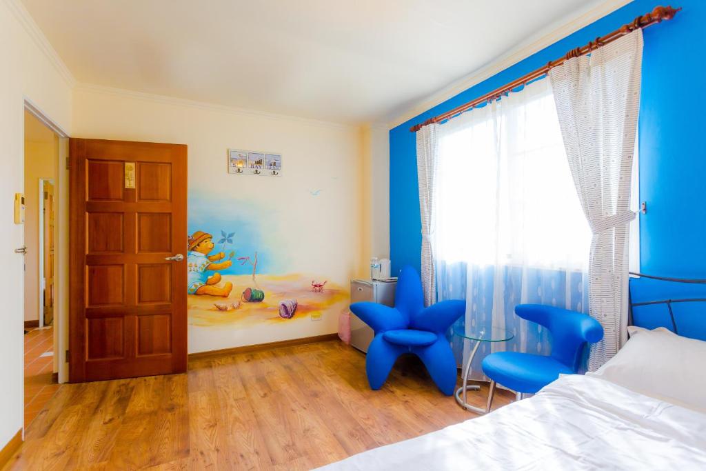 a bedroom with a bed and a childs room with a toy room at Dream House in Pinghe