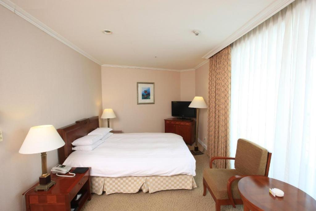 Postel nebo postele na pokoji v ubytování High1 Palace Hotel and CC