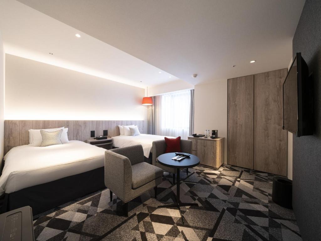 Postel nebo postele na pokoji v ubytování Hotel JAL City Toyama