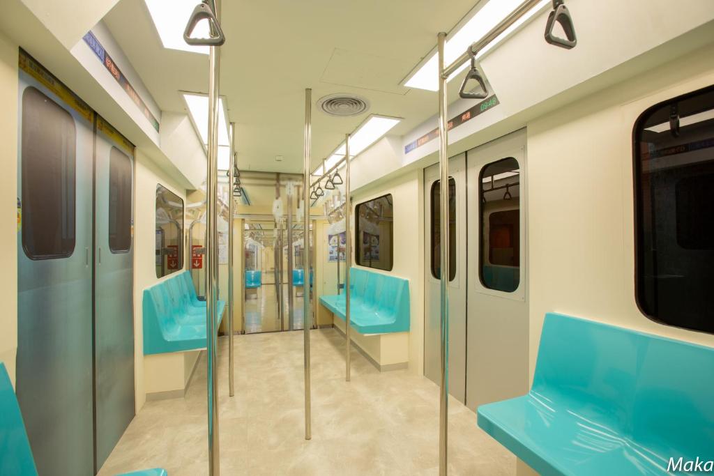 a subway car with blue seats in a train at You Want Motel in Xizhi