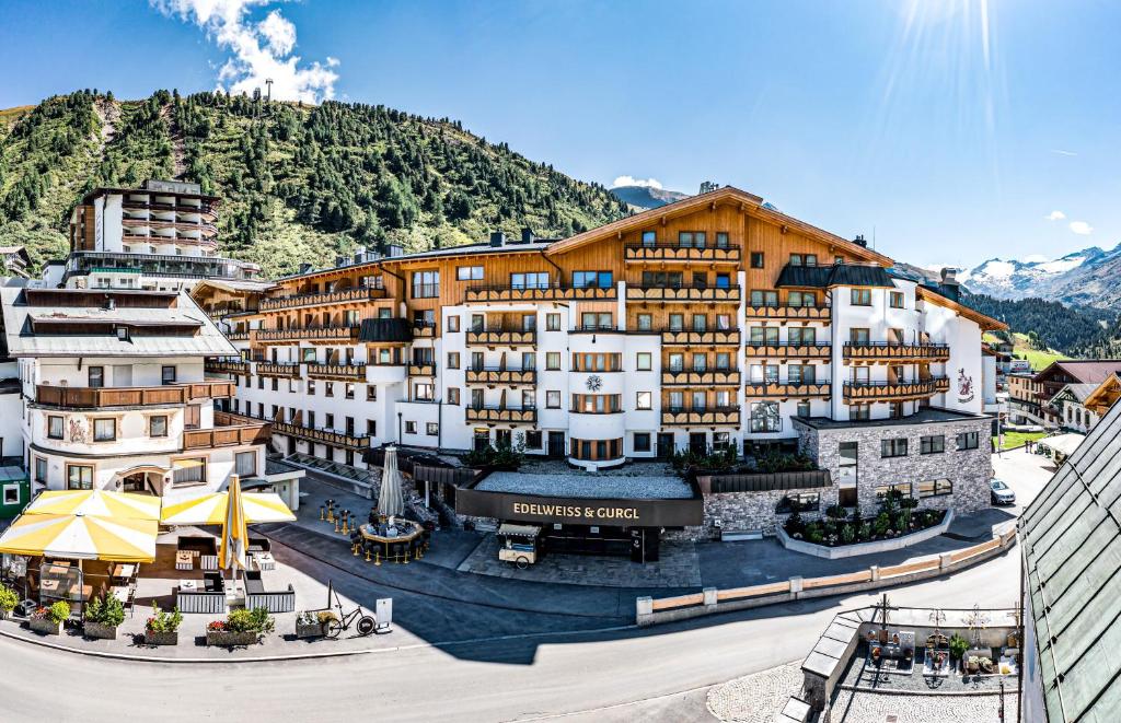 a rendering of a hotel with mountains in the background at Hotel Edelweiss & Gurgl in Obergurgl