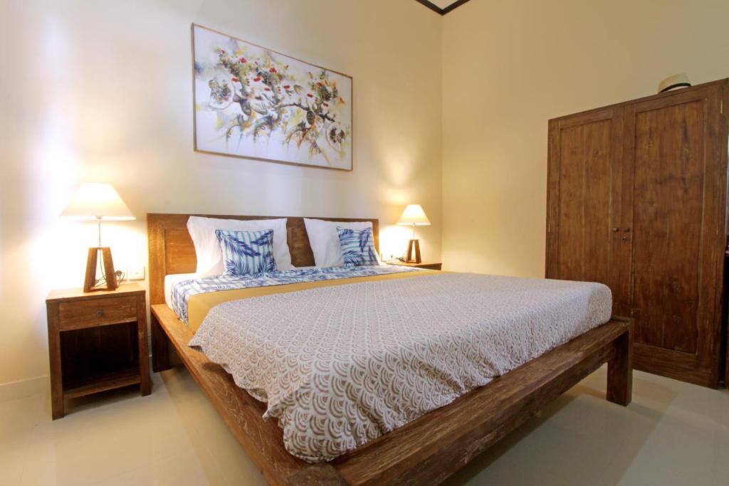 Postel nebo postele na pokoji v ubytování Sari House Ubud - Balinese Style Homestay
