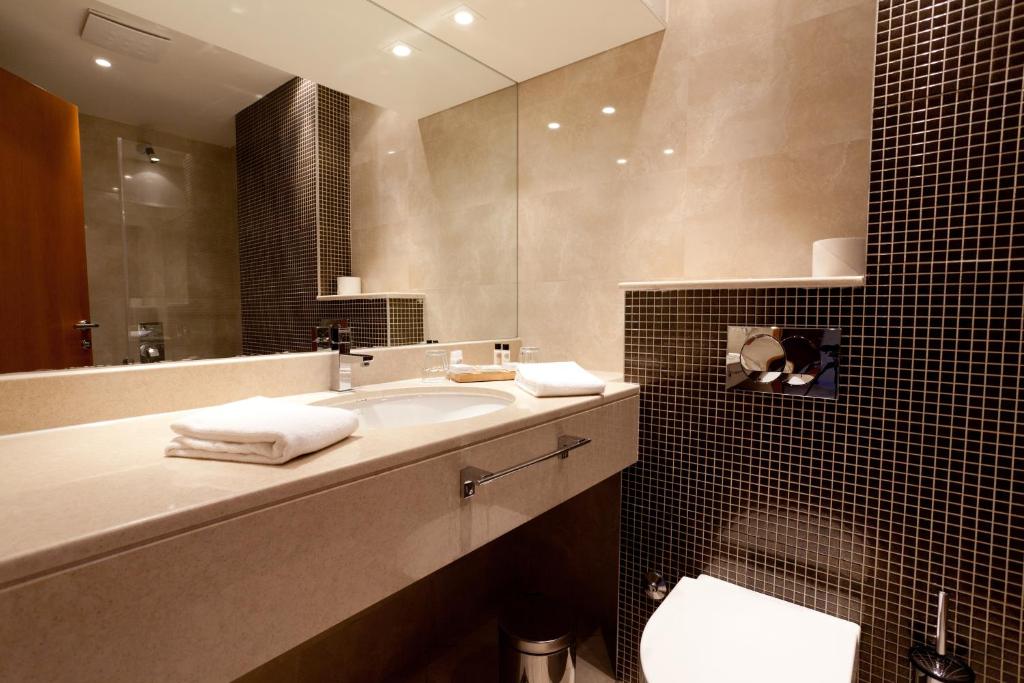 a bathroom with a sink and a mirror at Blue Waves Resort in Malinska