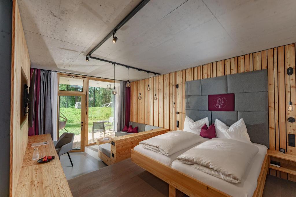 A bed or beds in a room at Naturhotel Lärchenhof