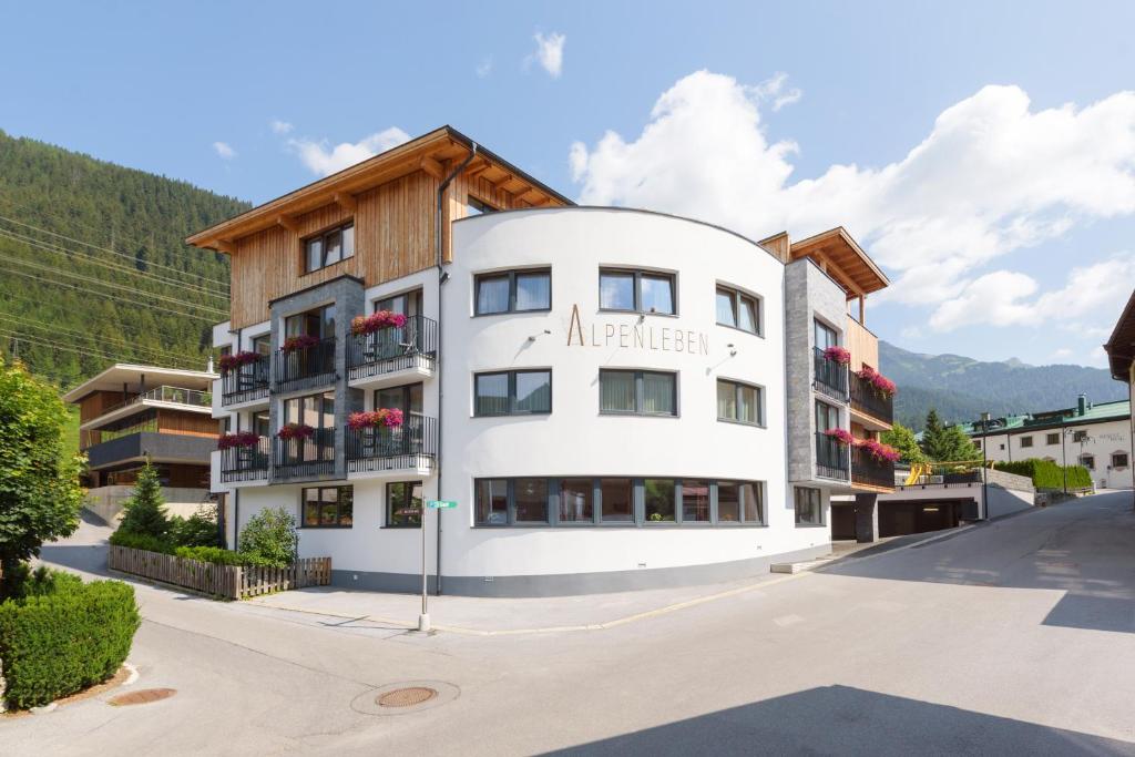 a large white building with a wooden roof at Anthony's Peaks & Pillows in Sankt Anton am Arlberg