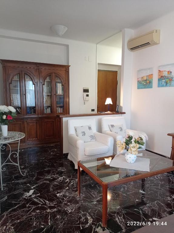 a living room with a white couch and a coffee table at DOWN TOWN EMILY in La Spezia
