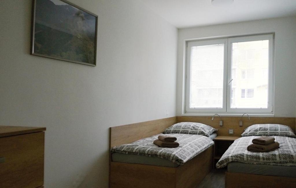 Postel nebo postele na pokoji v ubytování Rezidence Bělehradská