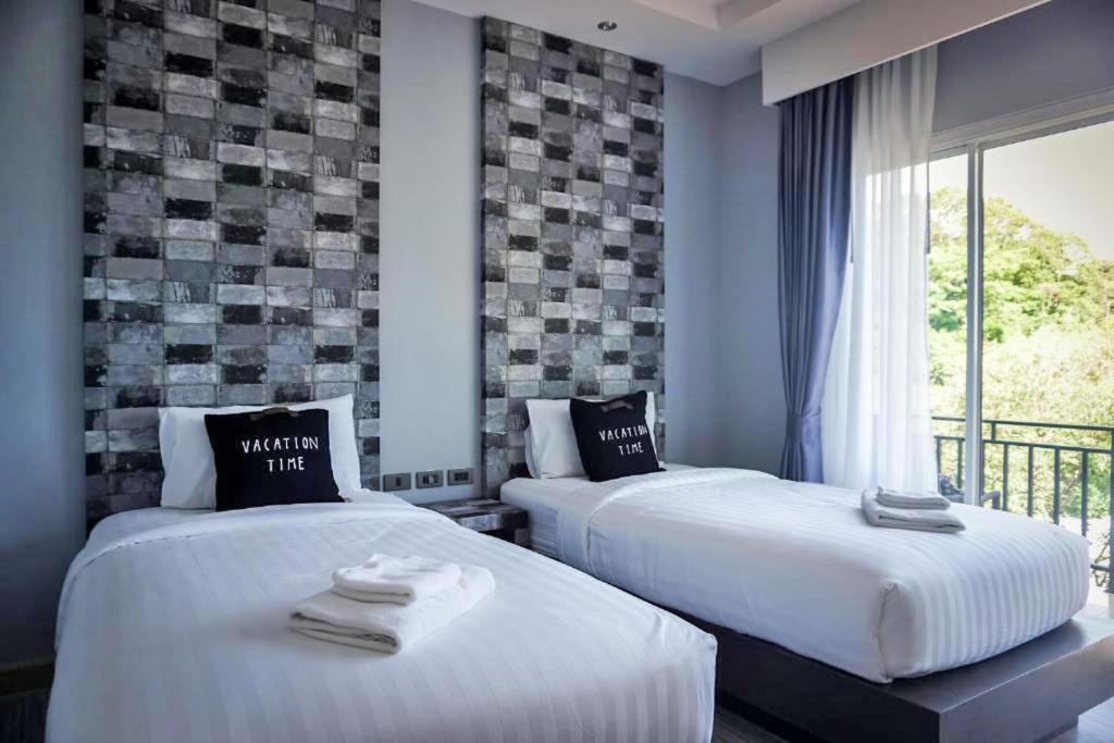 Postel nebo postele na pokoji v ubytování U Rip Resort Phi Phi Hotel