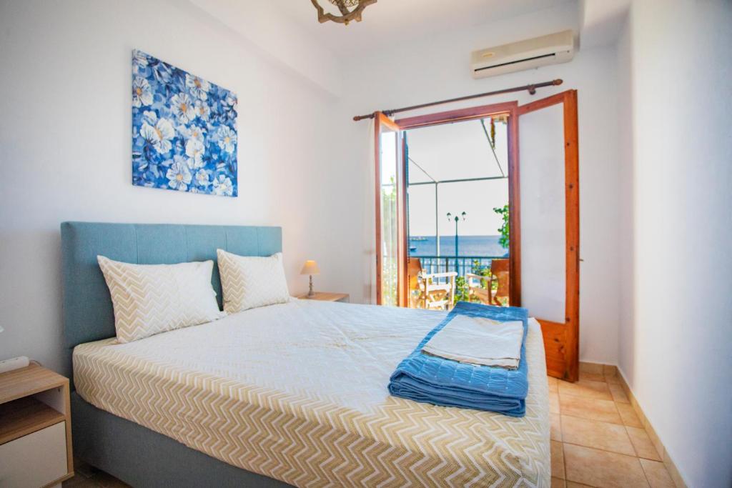 a bedroom with a bed with a view of the ocean at Notos Sea Front Apartment in Glossa