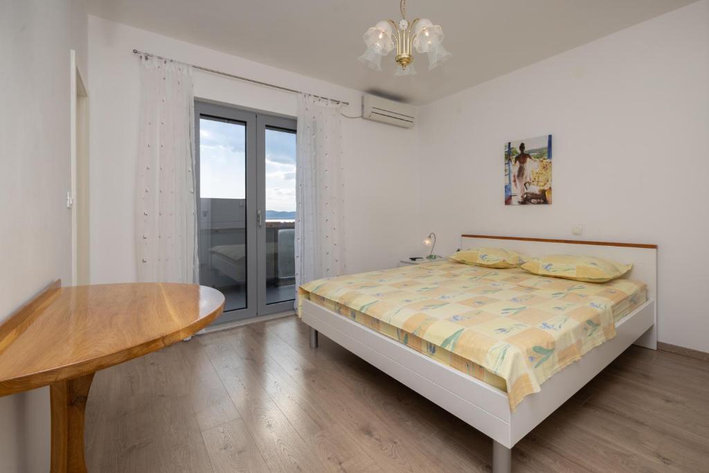 Postel nebo postele na pokoji v ubytování Family apartments - Guesthouse Vranješ