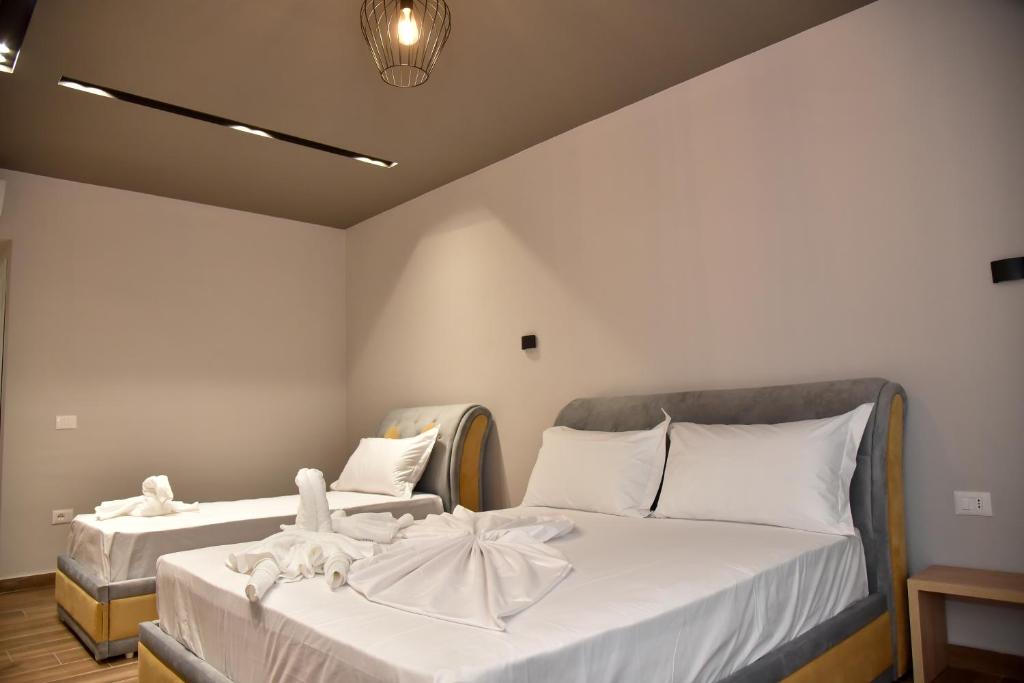 Postel nebo postele na pokoji v ubytování Hotel Lubjana