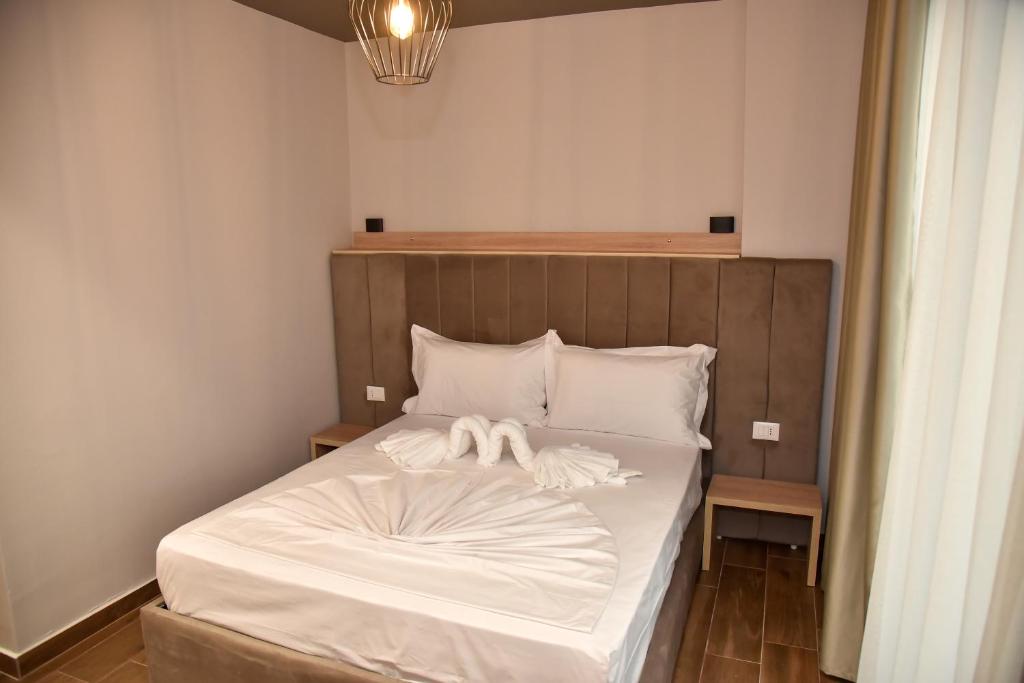 Postel nebo postele na pokoji v ubytování Hotel Lubjana