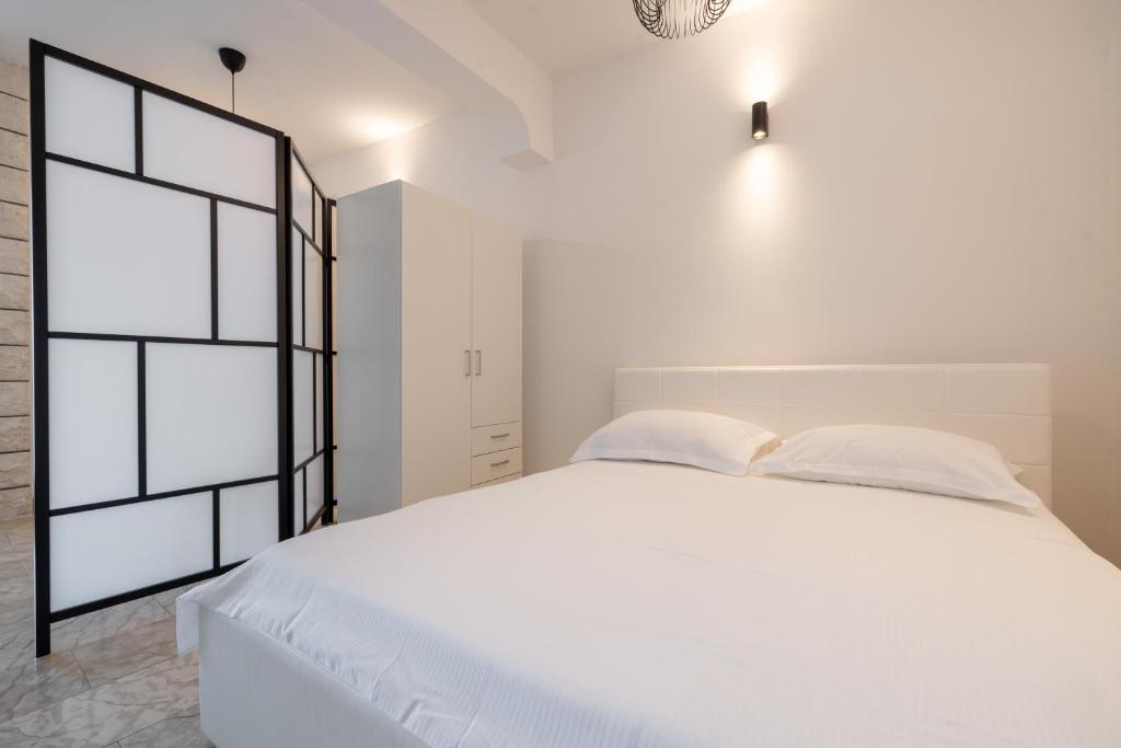 Postel nebo postele na pokoji v ubytování Family apartments - Guesthouse Vranješ