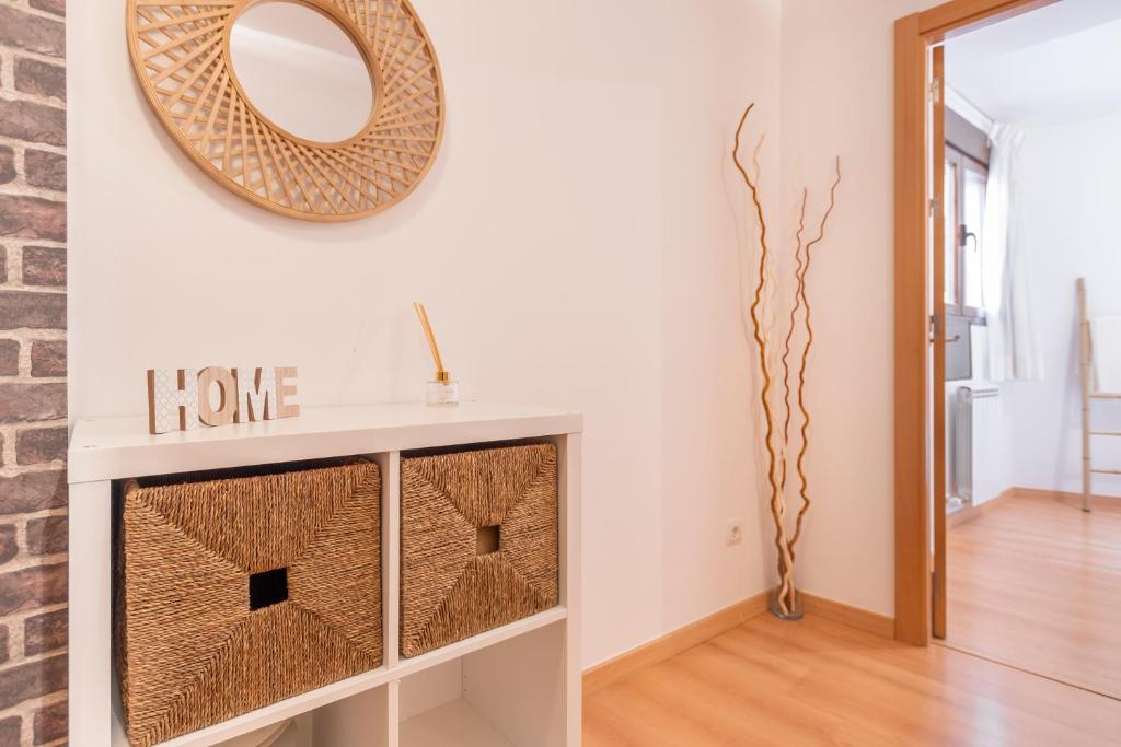 a living room with a mirror on the wall at Vivienda Teruel Mudejar in Teruel